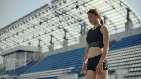 A-time-lapse-portrait-of-beautiful-woman-running-on-the-stadium-bleachers-with-concentrated-deep-breathing-and-motivating-myself-and-consciousness-for-the-race.-Discard-unnecessary-emotions-and-tune-in-to-win-preparing-for-the-race